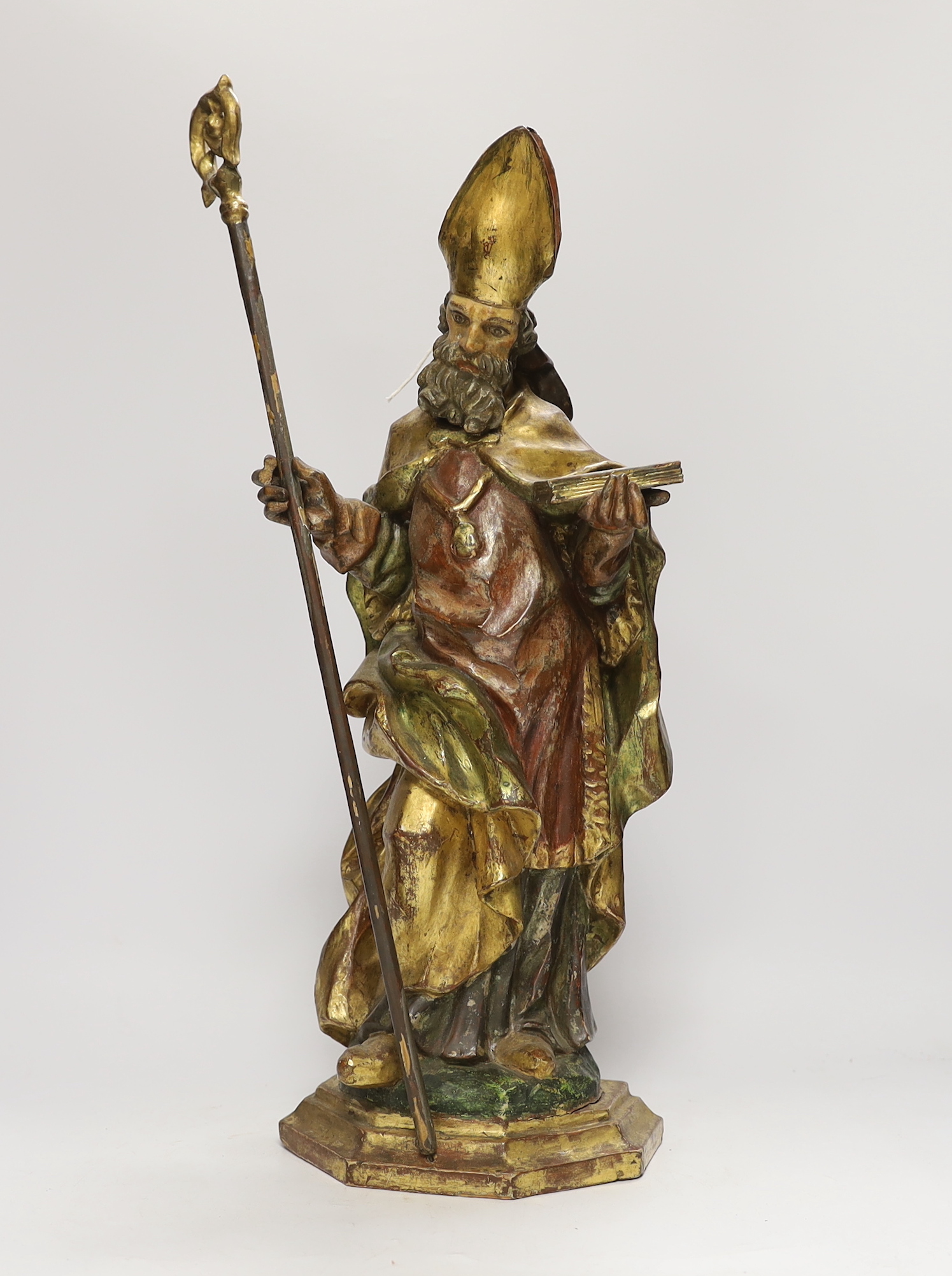 An Italian or Austrian carved gilt painted statue of a saint with staff, 48cm high